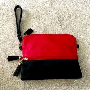 Red and black crossbody bag with 2 outside pockets. has a removable strap. new.